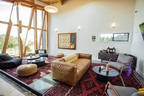 TV, fireplace - Dune Cabin - The Dune Cabin is well-appointed and uniquely designed and comfortably sleeps 6 guests. Private bedroom with queen bed, open loft with twin beds, and dinette that converts to a full size bed (Coos Bay)