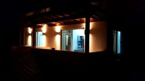 A building with a covered porch and multiple windows. - Modern Apartment in La Ceiba ‼️No Cleaning Fee‼️ (La Ceiba)
