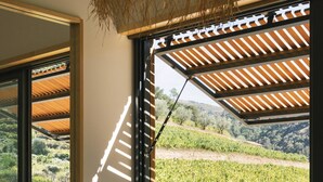 A bedroom with a large window, a bed, and a view of a vineyard. - Casa do Lagar by Quinta de Recião (Lamego)