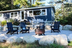 A cabin with a deck, outdoor seating, and a fire pit. - Beautiful waterfront property (Chesterville)