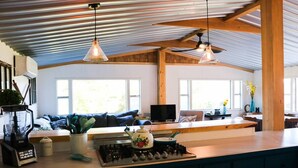 A modern kitchen with a central island, a blender, a kettle, and a stove. - Beautiful waterfront property (Chesterville)