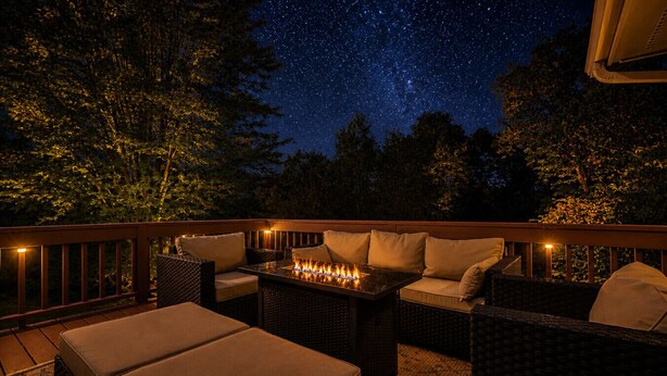 An outdoor patio with wicker furniture, a fire feature, and a starry night sky. - Fox Wood Path l HOT TUB l A&D Rise Getaways (Galena)