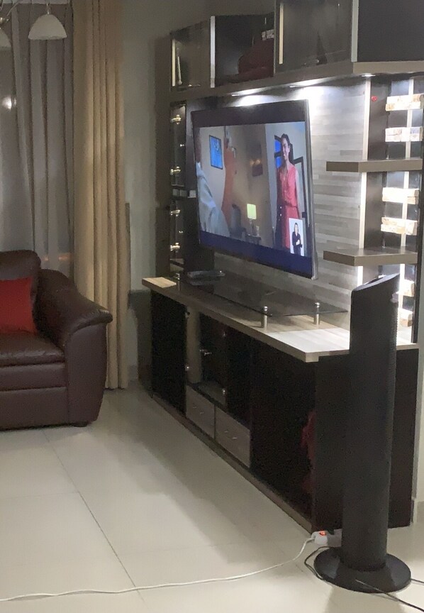 Relax in a comfortable seating area with a flat-screen TV and ample storage for your devices.
