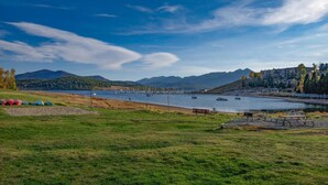 A lakeside view with boats, picnic tables, and a grassy area. - Lakeside One-Bedroom with Balcony/Views! Close to Keystone.  (Dillon)