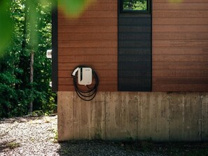 A building with a concrete foundation and a wooden exterior wall. - Chalet Röcka with hot tub and lake access! (Chertsey)