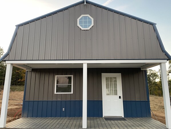 A large, single-story building with a gabled roof and a prominent octagonal window.