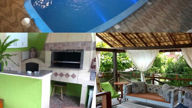 A swimming pool with a tiled deck, a barbecue area with a grill, and outdoor seating with cushions. - Dell osky Pousada (Florianópolis)