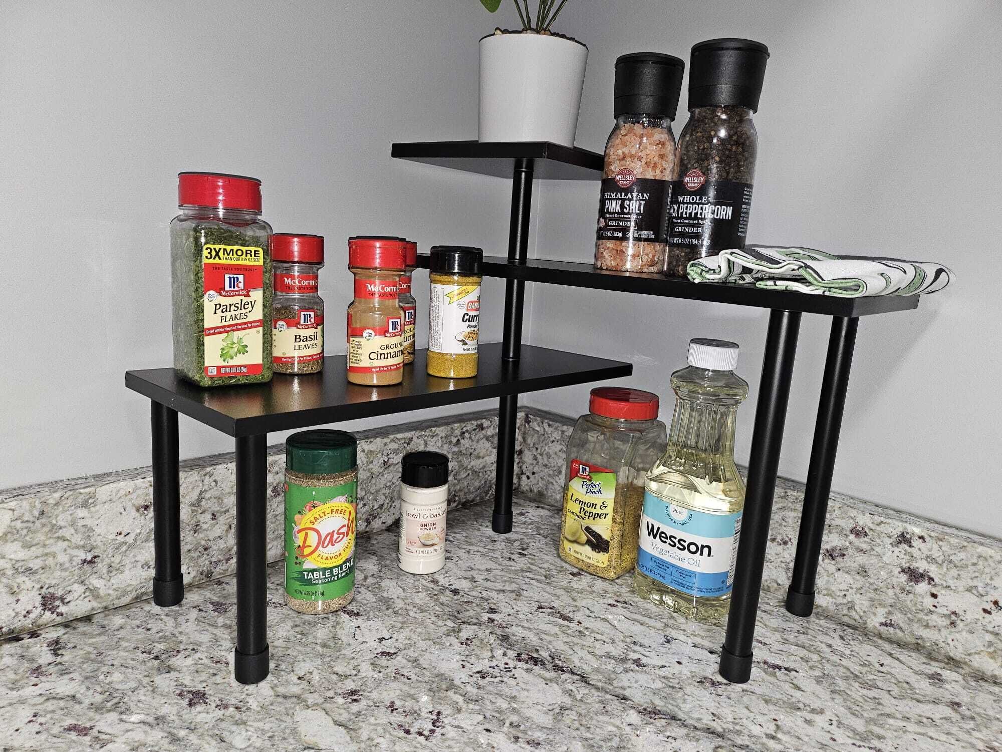A kitchen shelf with various condiments and spices.