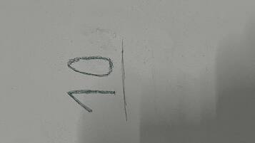 A hand-drawn sketch of a simple geometric shape, possibly a circle or oval, and a line.