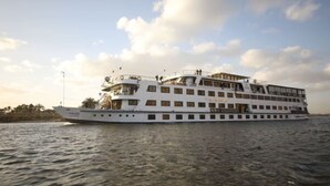 A large, multi-deck cruise ship with multiple levels of balconies and a prominent upper deck. - River Boat - Double Room with Private Bathroom (Cairo)