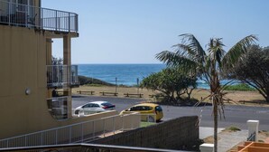 A coastal view with a building, a road, and a beach. - Breakers 1/8- Stone Real Estate Yamba (Yamba)