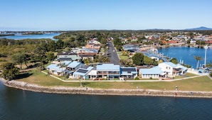 Un área residencial costera con casas, un puerto deportivo y vista al mar.