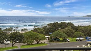 A coastal view with a beach, parked cars, and a sign for 'Cobb's Park'. - Breakers 2/12- Stone Real Estate Yamba (Yamba)
