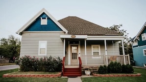 A two-story house with a front porch, a small front yard, and a mailbox. - Cool, Trendy house in Dodge City! The Painted Cow (Dodge City)