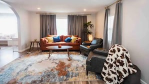 A modern living room with a sofa set, a coffee table, and a patterned rug. - Cool, Trendy house in Dodge City! The Painted Cow (Dodge City)