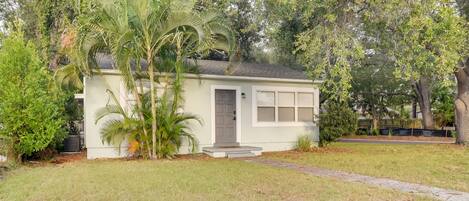 A single-story house with a front door, a small porch, and a garage.