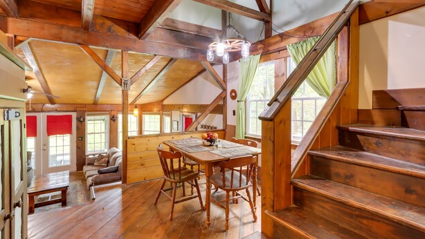 A wooden interior with a dining table, chairs, and a staircase. - Mountaintop Ellijay Cabin w/ Private Hot Tub (Ellijay)