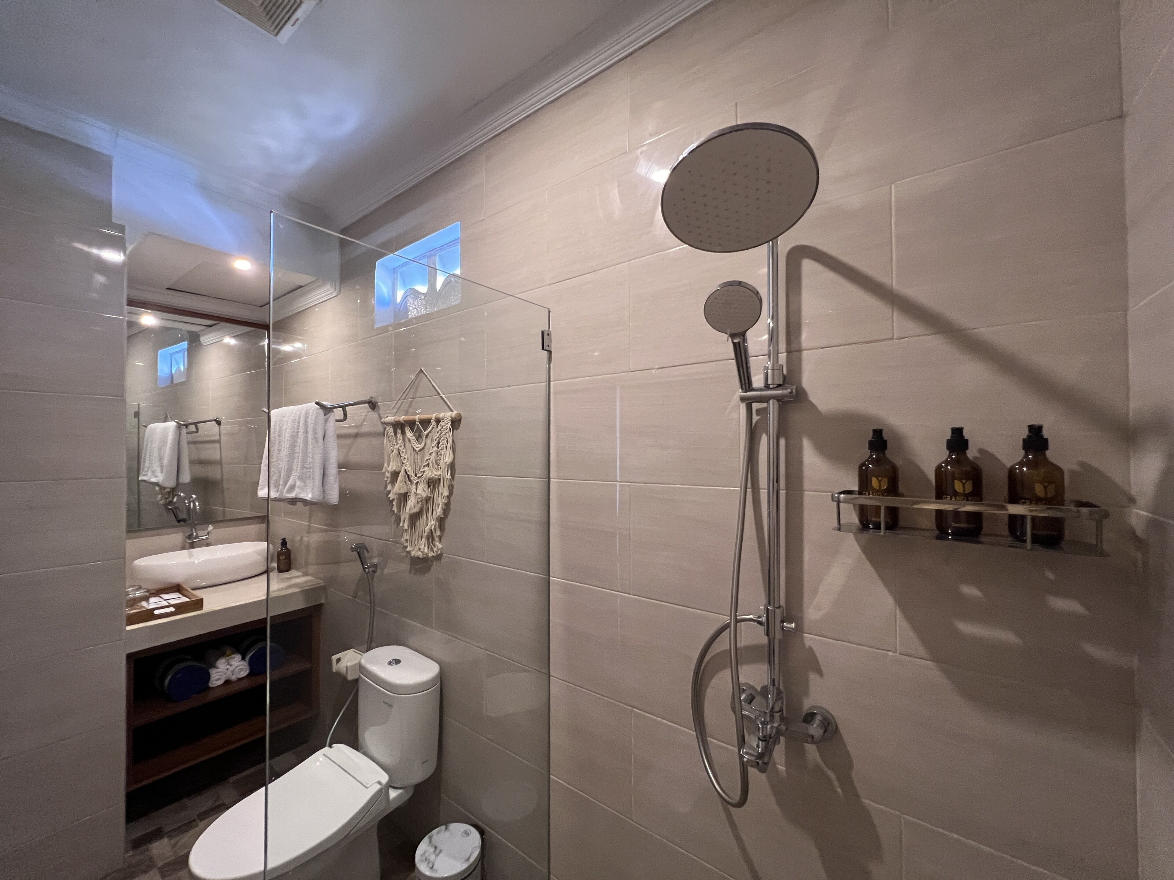 A modern bathroom with a toilet, sink, and shower.