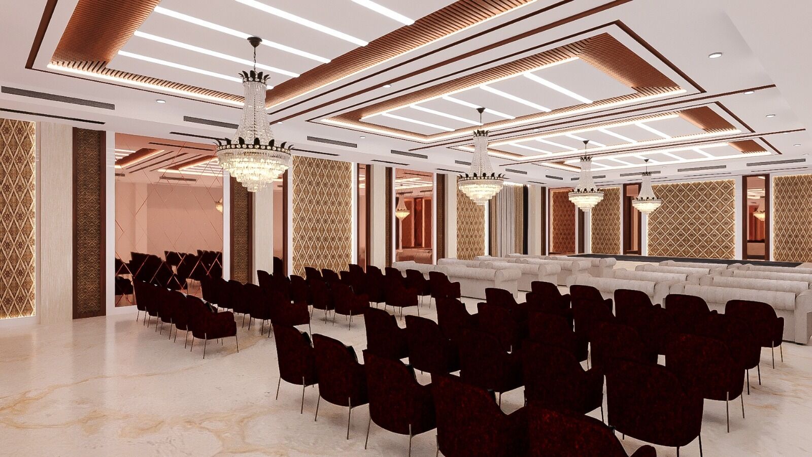 A spacious conference room with rows of chairs, a large chandelier, and patterned walls.