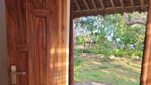 A wooden door leading to a stone pathway.