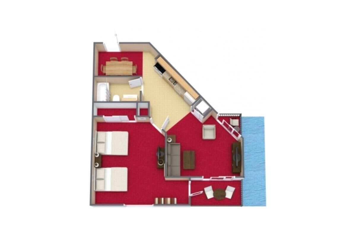 A floor plan of a hotel room with a bed, a desk, a chair, a small table, a sofa, and a window.