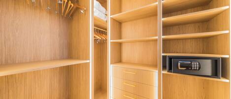 A wooden closet with multiple shelves, drawers, and hanging space.