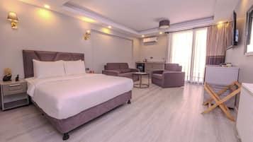 Deluxe Room with Balcony | In-room safe, laptop workspace, blackout drapes, soundproofing