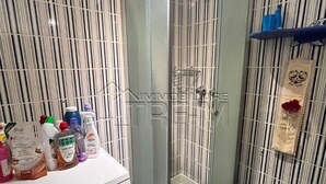 A bathroom with a glass-enclosed shower, a washing machine, a bidet, and striped wall tiles. - Luxury 4beds ski-in&out steps from center     (cervinia)