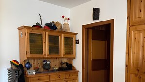 A kitchen with wooden cabinets, a countertop, and a dining table.