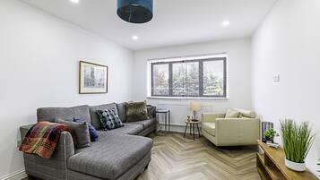 Basic Apartment, Multiple Beds | Living area | TV