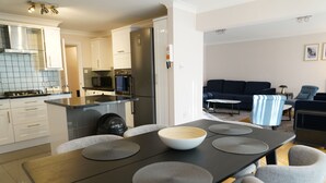 A modern kitchen with a dining area. - Lady Jane Court (Cambridge)