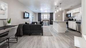 A modern kitchen with white cabinets, a microwave, and a dishwasher. - 2BR The Cardinal C! Montrose, Downtown MedCenter ⭐️⭐️⭐️⭐️⭐️ (Houston)