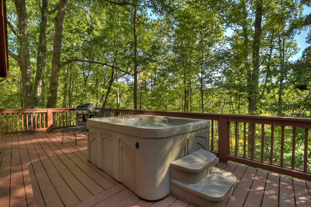 Relax at Moon Pond, this Pet-friendly oasis boasts a hot tub, firepit, dockside fishing, scenic hikes, and seamless WiFi for unforgettable retreats