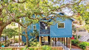 A blue treehouse with a wooden deck and a staircase leading up to it. - Folly Oasis | Beachside Home w. Pool + Parking (Folly Beach)