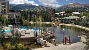 A resort with a swimming pool, a dock, and a view of mountains. - Hyatt Residence Club - Main Street Station 2 Bedroom (Breckenridge)