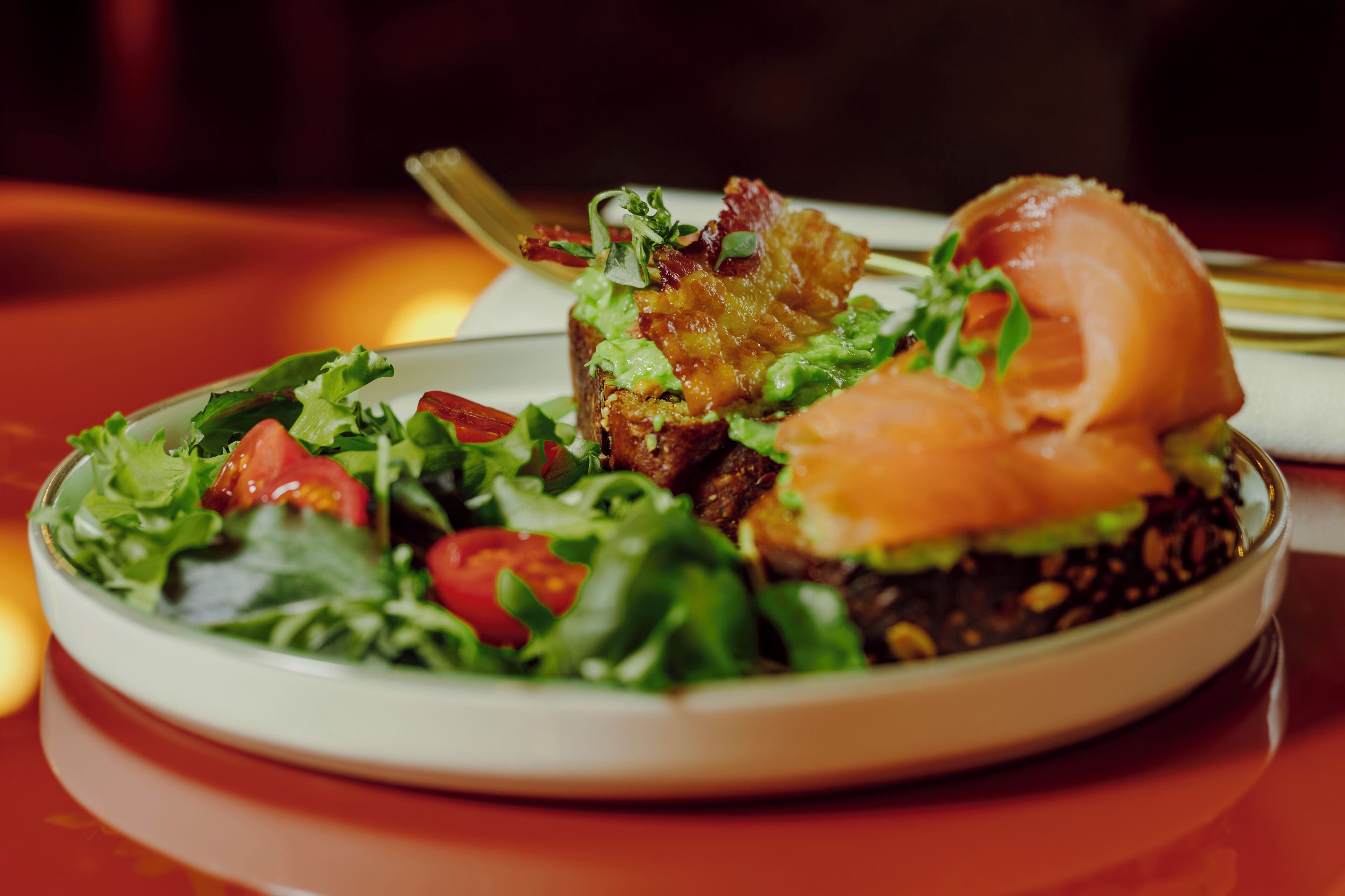 A plate with a sandwich and salad.