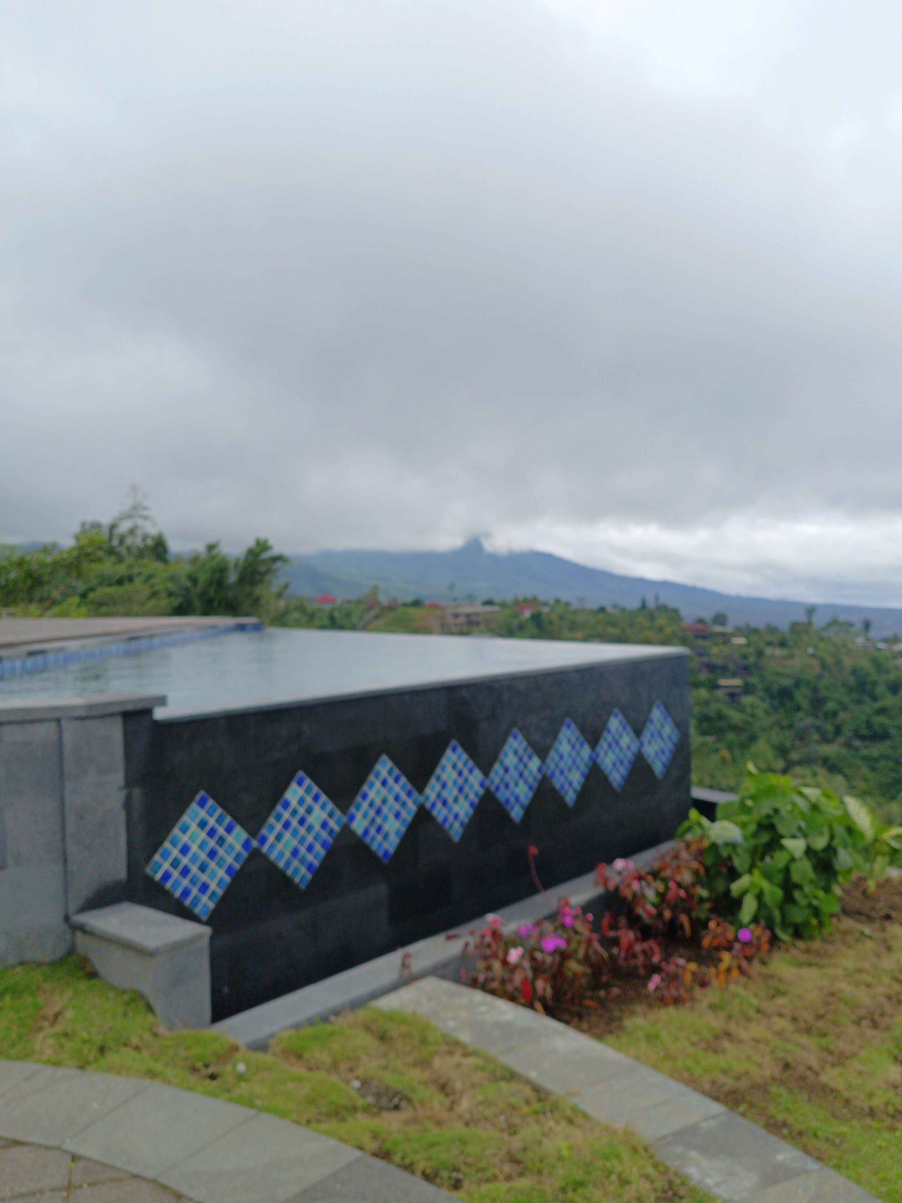 A building with a tiled wall featuring a geometric pattern.