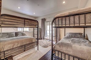 A bedroom with bunk beds, a fluffy rug, and a window with curtains. - Lofts 7 C Summary:<br>Di (Brian Head)
