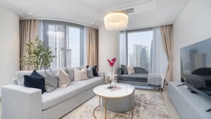 A modern living room with a sofa, a coffee table, and a television.