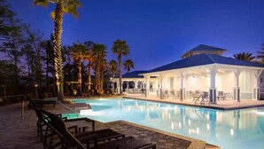 A pool area with lounge chairs and a covered seating area at dusk. - Seagrove Beach Paradise: Salty Days - Your Dream 30A Getaway! (Santa Rosa Beach)