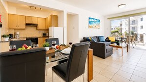A modern apartment with a kitchen, dining area, living room, and balcony. - 2BR Apartment with Pool - Poppy by Premier (Paralimni)
