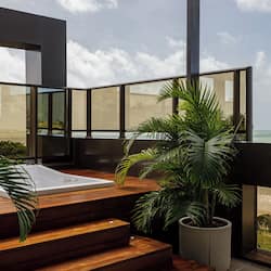 Relax on the balcony with a hot tub and enjoy the scenic beach view.