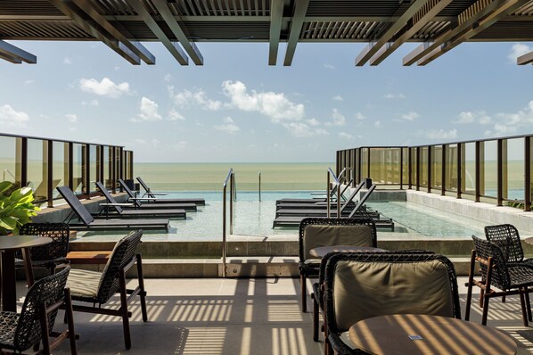Outdoor pool, open 8:00 AM to 10:00 PM, pool umbrellas, sun loungers