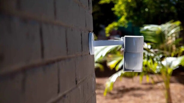 A security camera mounted on a brick wall. - Chic Modern House on Neasden - 2085 (Bulawayo)