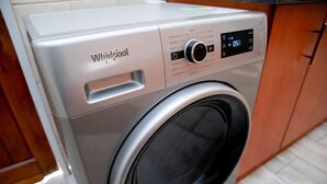 A Whirlpool washing machine with a digital control panel and a front-loading door. - Chic Modern House on Neasden - 2085 (Bulawayo)
