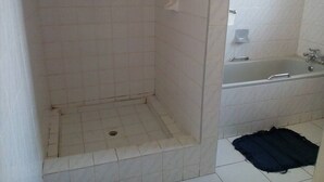A bathroom with a shower, a bathtub, and a toilet. - Neat guest suite with office corner - 2101 (Harare)