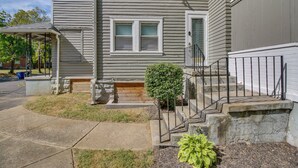 A two-story house with a covered porch, a small front yard with a potted plant, and a visible front door. - Sunny + Spacious Dayton Condo ~ 1 Mi to Downtown! (Dayton)