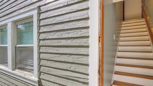 A staircase with wooden steps and a handrail, leading to an interior space. - Sunny + Spacious Dayton Condo ~ 1 Mi to Downtown! (Dayton)