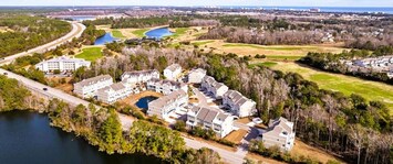 Aerial view of our cozy townhome nestled among lush golf courses, minutes from beach & resort pool! Check us out for latest promotions!!