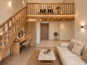 A modern interior with a wooden staircase, a desk with a chair, a sofa, and a coffee table.